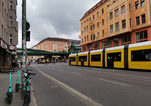 Street scene with yellow tram stopped on the road before crosswalk in Prenzlauer Berg district of Berlin
