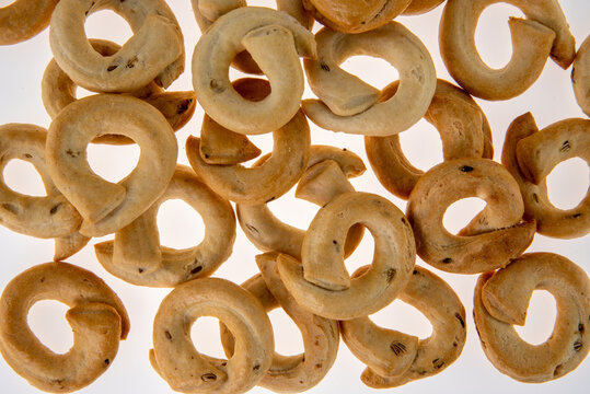 Taralli tarallini or tarallucci with fennel seeds from Puglia, Italy, isolated on white in top view