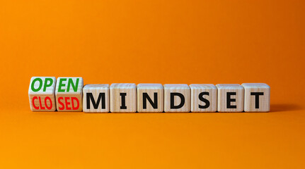 Open or closed mindset symbol. Turned wooden cubes and changed concept words closed mindset to open mindset. Beautiful orange background, copy space. Business open or closed mindset concept.