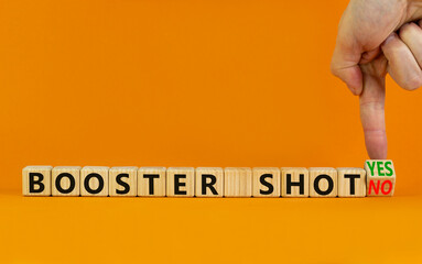 Covid-19 booster vaccine shot yes or no symbol. Doctor turns cubes and changes words booster shot no to booster shot yes. Beautiful orange background copy space. Covid-19 booster vaccine shot concept.
