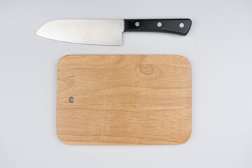 Wooden cutting board and knife isolated on white background, Arrange the components in a pattern. Top view. Space for text.
