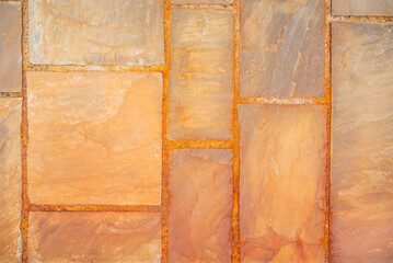 A tile with an orange tint, which was formed from the oxidation of metal pieces between the tiles