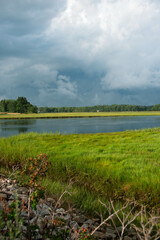 landscape with river inlet and stormy skies