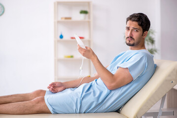 Obraz premium Young male patient in transfusion concept