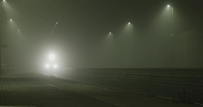 Train arriving at the station in the foggy night