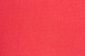 Red knitted wool texture background for close-up photos.