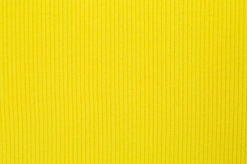 Yellow background texture of knitted wool. Knitted fabric.