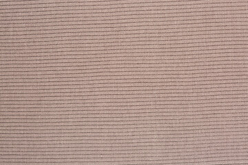 Texture of beige knitted sweater fabric.