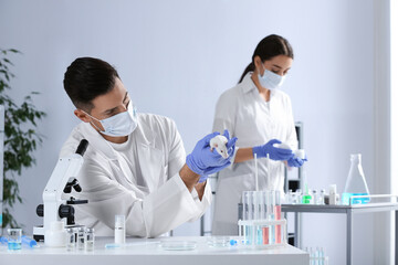 Scientist with rat in chemical laboratory. Animal testing