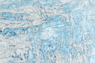 Crackle paint texture. Blue  grunge pattern of natural enamel paint crackle. Cool texture of cracks, stains, scratches, splashes for print and design. Old painted concrete wall.