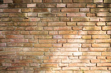 light and shadow on orange old brick wall