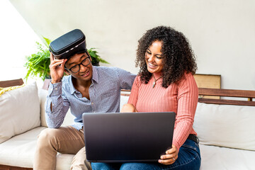young people of generation z using meta verse reality, biracial woman showing progrss at her friend with vr glasses for augmented reality