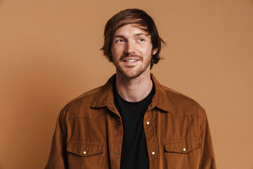 White unshaven man in shirt smiling and looking aside