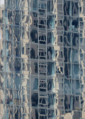 Reflections in glass facia of hi-rise building