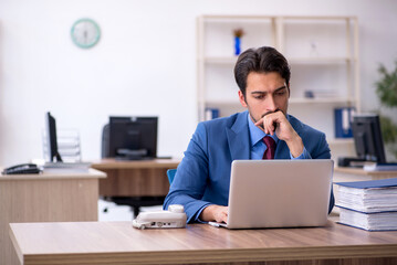 Young male employee working in the office