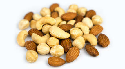 Mixed nuts almond, cashew, hazelnut isolated on white background. Close-up. Banner. Selective focus.