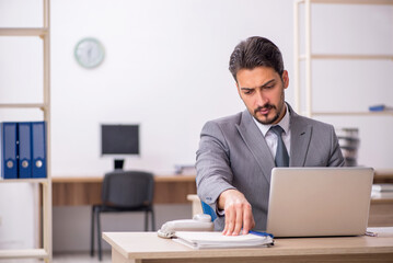 Young male employee working in the office