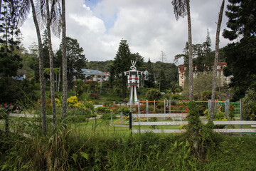 Obraz premium The Taman Pertabalan gardens with the vintage colonial era clock tower in the town of Tanah Rata in the Cameron Highlands.