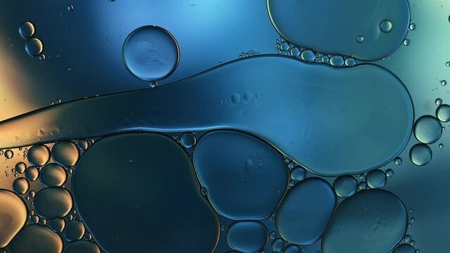 Abstract Colorful Food Oil Drops Bubbles and spheres Flowing on Water Surface, macro Videography