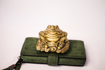 Golden three-legged toad to bring good luck and material well-being into life.