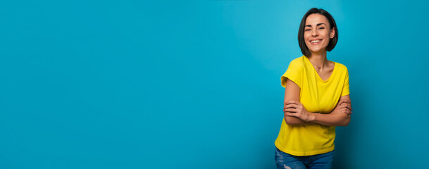 Wide banner photo of smiling cute brunette woman with stylish hairstyle in yellow t-shirt while she...