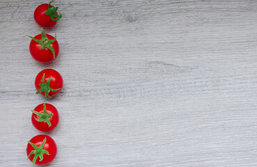 Small red tomatoes lie in a row on the left.