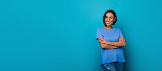 Wide banner photo of happy beautiful young brunette woman with stylish hairstyle in blue t-shirt...