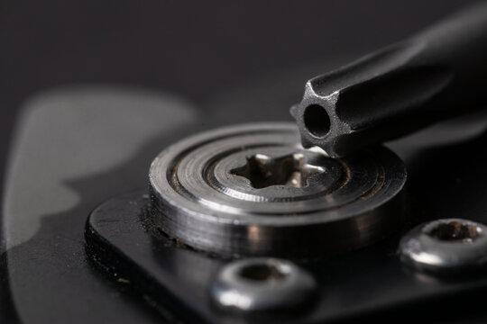Close up macro on screwdriver unscrewing torx screw