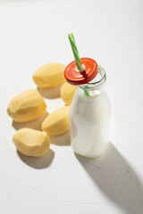 Potato milk concept. Bottle with potato milk on a white background. An alternative to animal...