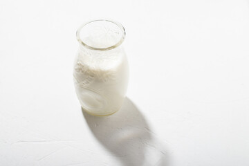Figured bottle with milk on a white background. Alternative milk from vegetable components.