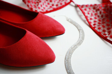 Composition with red female  shoes and accesories on light background