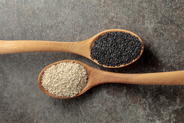 Wooden spoons with black and white sesame seeds.