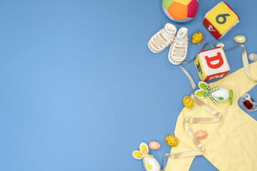 Baby nursery clothing mom bloggers desktop workspace with accessories on blue background