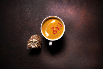 Orange color soup in a cup 