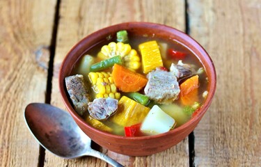 Mexican Beef Soup. Latin American soup with beef, potatoes, carrots, corn on the cob, green beans, peppers, Beef Broth,
copy space, place for text, country style 