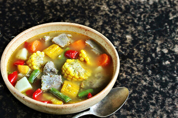 Mexican Beef Soup. Latin American soup with beef, potatoes, carrots, corn on the cob, green beans, peppers, Beef Broth,
copy space, place for text, country style 