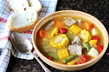 Mexican Beef Soup. Latin American soup with beef, potatoes, carrots, corn on the cob, green beans, peppers, Beef Broth,
copy space, place for text, country style 