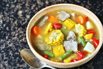 Mexican Beef Soup. Latin American soup with beef, potatoes, carrots, corn on the cob, green beans, peppers, Beef Broth,
copy space, place for text, country style 