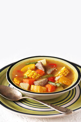 Mexican Beef Soup. Latin American soup with beef, potatoes, carrots, corn on the cob, green beans, peppers, Beef Broth,
copy space, place for text, country style 