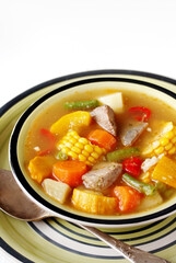 Mexican Beef Soup. Latin American soup with beef, potatoes, carrots, corn on the cob, green beans, peppers, Beef Broth,
copy space, place for text, country style 
