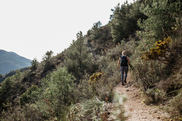 Obraz premium woman hiking in spain at the spanish mountains outdoors