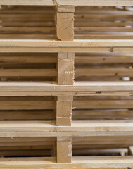 Pallet storage. Big pile. Wooden mountain. The pallets are located in the middle of the warehouse.