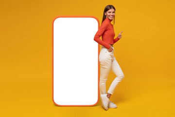 Woman standing and showing blank screen of huge phone and thumb up gesture, mockup for your app