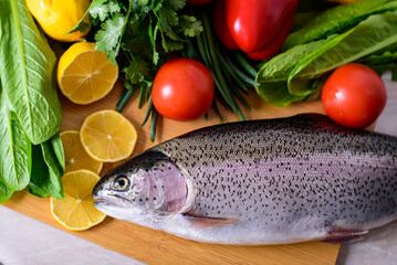 Fresh raw fish and food ingredients on table
