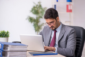 Young male employee working in the office