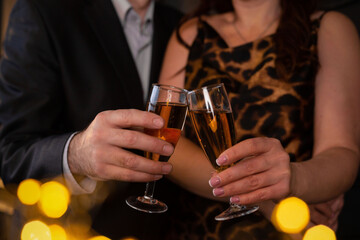 Two glasses of champagne in the hands of a man and a woman