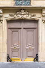 Paris, an ancient door, typical building in the 11e arrondissement
