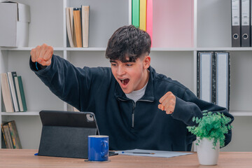 euphoric millennial student at home with laptop