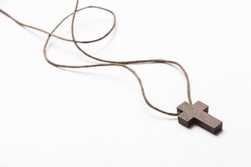 Christian cross isolated on light gray background with free space for writing. Christian cross on craft paper background.