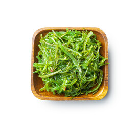 Green wakame. Seaweed salad in wooden bowl isolated on white background.